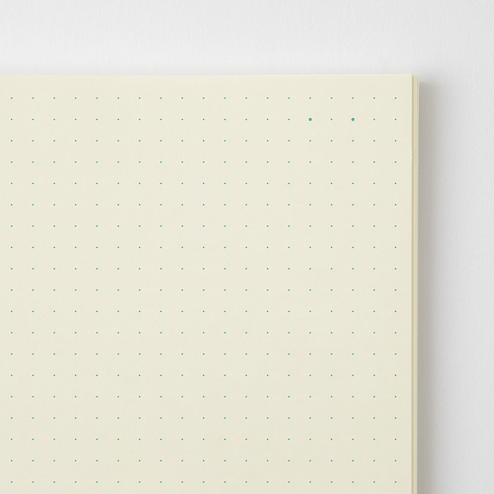 Notebook with dot grid on a light gray background