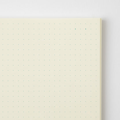 Notebook with dot grid on a light gray background