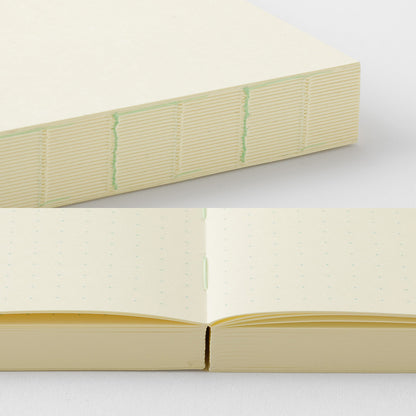 Open notebook with cream-colored pages on a white background